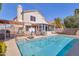 Sparkling pool with a covered patio, outdoor seating, and desert landscaping at 9211 W Charleston Ave, Peoria, AZ 85382