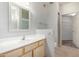 Bright bathroom with a single sink vanity, framed mirror, and tile flooring at 9455 E Raintree Dr # 1049, Scottsdale, AZ 85260