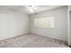 Simple bedroom with neutral carpet, a ceiling fan, and a bright window at 9455 E Raintree Dr # 1049, Scottsdale, AZ 85260