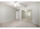 Bedroom featuring carpet, a ceiling fan, and mirrored closet doors at 9455 E Raintree Dr # 1049, Scottsdale, AZ 85260