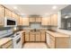 Well-lit kitchen featuring white appliances, light wood cabinetry, and a double basin sink at 9455 E Raintree Dr # 1049, Scottsdale, AZ 85260