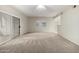 Open living room showing the sliding glass doors to the balcony and neutral colored carpet at 9455 E Raintree Dr # 1049, Scottsdale, AZ 85260