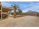 Large backyard featuring covered patio with dining, barbecue grill, pool, desert landscaping, and ample parking space at 9627 W Reno View Dr, Peoria, AZ 85345