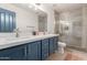 Bright bathroom with double sinks, quartz counters and a modern shower at 9627 W Reno View Dr, Peoria, AZ 85345