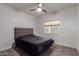 Bedroom features a ceiling fan and a window providing natural light at 9627 W Reno View Dr, Peoria, AZ 85345