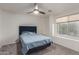 Bedroom features a ceiling fan and a window providing natural light at 9627 W Reno View Dr, Peoria, AZ 85345