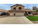 Two-story home showcasing a three-car garage and a well-manicured lawn at 9627 W Reno View Dr, Peoria, AZ 85345