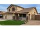 Two-story home featuring a three-car garage, desert landscaping, and green lawn at 9627 W Reno View Dr, Peoria, AZ 85345