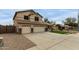 Two-story home featuring a three-car garage, desert landscaping, and green lawn at 9627 W Reno View Dr, Peoria, AZ 85345