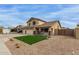 Two-story home featuring a three-car garage, desert landscaping, and green lawn at 9627 W Reno View Dr, Peoria, AZ 85345