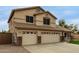 Two-story home featuring a three-car garage, desert landscaping, and a tiled roof at 9627 W Reno View Dr, Peoria, AZ 85345