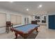 Entertaining game room with pool table and french door access to backyard at 9627 W Reno View Dr, Peoria, AZ 85345