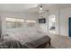 Spacious main bedroom with neutral carpet, a fan, and an ensuite bathroom at 9627 W Reno View Dr, Peoria, AZ 85345