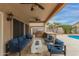 An outdoor patio seating area with built in grill and bar with ceiling fans at 9627 W Reno View Dr, Peoria, AZ 85345