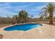 A beautiful outdoor pool with palm trees and a basketball hoop at 9627 W Reno View Dr, Peoria, AZ 85345