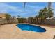 Backyard with a refreshing pool surrounded by palm trees and travertine decking, offering a serene outdoor escape at 9627 W Reno View Dr, Peoria, AZ 85345