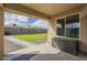 The covered patio offers a view of the backyard and includes a useful storage box at 9965 W Devonshire Dr, Arizona City, AZ 85123