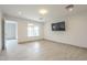 Spacious bedroom features tile flooring, mounted TV, and an adjacent outdoor patio at 9965 W Devonshire Dr, Arizona City, AZ 85123