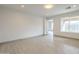 Bright bedroom featuring tile floors and a large window with outdoor views at 9965 W Devonshire Dr, Arizona City, AZ 85123