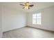 Bright bedroom with tile floors, ceiling fan, and large window at 9965 W Devonshire Dr, Arizona City, AZ 85123