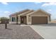 Charming single-story home with desert landscaping, a two-car garage and concrete driveway at 9965 W Devonshire Dr, Arizona City, AZ 85123