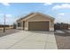 Charming single-story home featuring desert landscaping, a two-car garage and extended driveway at 9965 W Devonshire Dr, Arizona City, AZ 85123