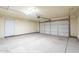 Spacious two-car garage with a large door and automatic door opener at 9965 W Devonshire Dr, Arizona City, AZ 85123