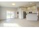 Open concept kitchen featuring stainless steel appliances, white cabinets, and tile floors at 9965 W Devonshire Dr, Arizona City, AZ 85123