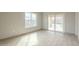 Living room featuring sliding glass doors, tile flooring, and neutral gray paint at 9965 W Devonshire Dr, Arizona City, AZ 85123