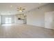 Spacious living room with open layout, recessed lighting, and light tile floors at 9965 W Devonshire Dr, Arizona City, AZ 85123