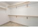 Walk-in closet with wood shelves and rods for clothing storage at 9965 W Devonshire Dr, Arizona City, AZ 85123