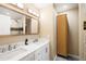 Bathroom featuring double sinks, large mirror, and cabinet for storing toiletries at 101 N 7Th St # 137, Phoenix, AZ 85034