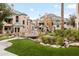 Exterior view of community homes and green space, including a charming bridge and water feature at 101 N 7Th St # 137, Phoenix, AZ 85034