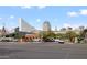 Street view of building with multiple skyscrapers nearby, with visible parked cars and a school bus at 101 N 7Th St # 137, Phoenix, AZ 85034