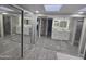 Modern bathroom with double vanity, lighted mirrors, and marble-look tile at 10328 E Michigan Ave, Sun Lakes, AZ 85248