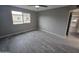 Spacious bedroom features wood-look tile flooring, neutral paint, ceiling fan, and a window with natural light at 10328 E Michigan Ave, Sun Lakes, AZ 85248