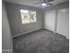 Bright bedroom featuring neutral paint, plush carpet, window, and a closet with sliding doors at 10328 E Michigan Ave, Sun Lakes, AZ 85248