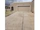 Attached two car garage with driveway and neutral stucco exterior with brick accenting at 10328 E Michigan Ave, Sun Lakes, AZ 85248