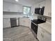 Bright kitchen featuring white cabinets, stainless steel appliances, and light countertops at 10328 E Michigan Ave, Sun Lakes, AZ 85248