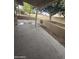 Covered patio with concrete flooring overlooking trees and block wall at 10328 E Michigan Ave, Sun Lakes, AZ 85248