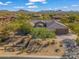 Expansive aerial view showcasing a home with desert landscaping nestled among other residences at 10829 E Volterra Ct, Scottsdale, AZ 85262