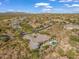 Wide aerial view showcasing an exclusive desert community with a home featuring a private pool at 10829 E Volterra Ct, Scottsdale, AZ 85262