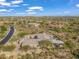 Expansive aerial view of a luxury home featuring a private pool and surrounding desert landscape at 10829 E Volterra Ct, Scottsdale, AZ 85262