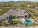 Stunning aerial view of backyard featuring desert landscaping, covered patio and sparkling pool with a patio at 10829 E Volterra Ct, Scottsdale, AZ 85262