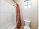 Bathroom featuring shower with curtain, toilet, and small window providing natural light at 10829 E Volterra Ct, Scottsdale, AZ 85262