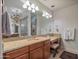 Bathroom featuring vanity, mirror, granite countertop, chandelier, and tile shower at 10829 E Volterra Ct, Scottsdale, AZ 85262