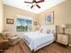 Inviting bedroom with a cozy armchair, soft natural lighting, and serene views from the large window at 10829 E Volterra Ct, Scottsdale, AZ 85262