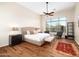 Spacious bedroom featuring a large window with desert views, dark wood floors, and stylish furniture at 10829 E Volterra Ct, Scottsdale, AZ 85262