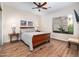 Warm bedroom featuring a bed with beautiful wood floors and lots of natural light from the window at 10829 E Volterra Ct, Scottsdale, AZ 85262