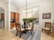 Bright dining area with large window, stylish lighting and a glass dining table at 10829 E Volterra Ct, Scottsdale, AZ 85262